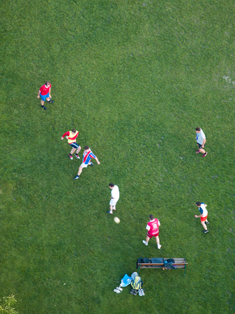 Vienna, Austria - March 02, 2014 : Young men playing soccer on the green grass in Danube Park in Vienna, shot from the TV towerのeditorial素材
