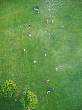Vienna, Austria - March 02, 2014 : Young men playing soccer on the green grass in Danube Park in Vienna, shot from the TV towerのeditorial素材