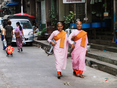 Yangon,  - February 24, 2011 : Two young female monks walking on the street in Yangonのeditorial素材