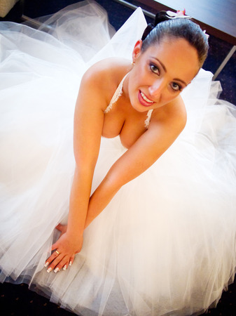 Bride in a wedding dress sitting on the floorの写真素材