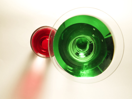 Two cocktails - big one and a shot. The big one is green "Martini", whereas the shot is "The Kiss"の写真素材