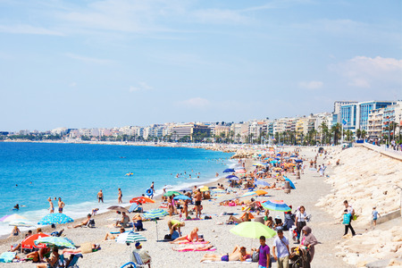 Beautiful beach of Nice with people sunbathingのeditorial素材