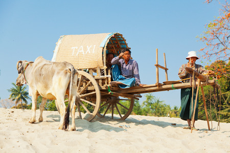 Mingun, Myanmar - February 28, 2011 : Two burmese men waiting for tourists in Mingun to give them an...