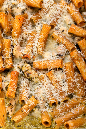 Baked Penne pasta with parmesan cheese. Shot from above. Close up, vertical shotの写真素材