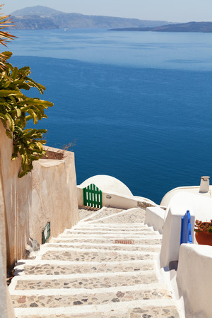 Street view in Oia, Santorini. The sea and volcano on backgroundの写真素材
