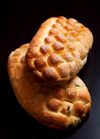 Two homemade buns shot on a dark backgroundの写真素材
