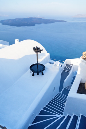Street view and stairs in Oia, Santorini. The sea and caldera on background. Shot at sunriseの写真素材