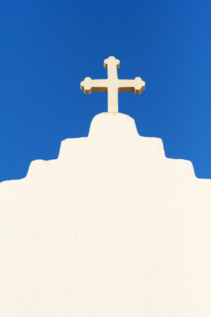 Details of white church cross in Mykonos, Greece. Vertical shotの写真素材