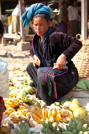 Heho, Myanmar - March 02, 2011 - Senior Burmese woman selling bananas at five-day market while sitting on the groundのeditorial素材