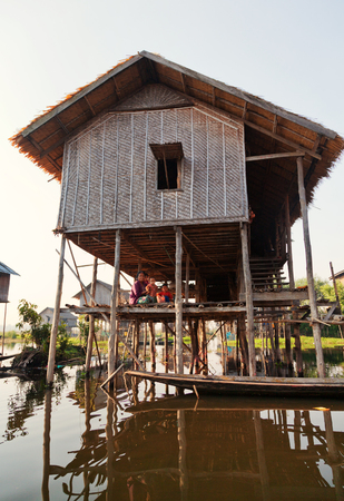 Heho, Myanmar - March 02, 2011 - Burmese mothers nursering their kids underneath their house located in the middle of the lakeのeditorial素材