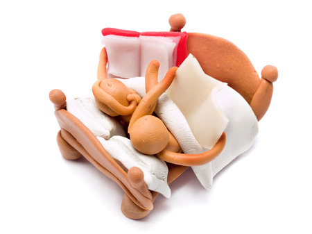 Man and Woman made of plasticine in Bed reading a book and a newspaperの写真素材