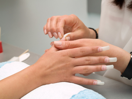 Girl fingernails being manicured.の写真素材