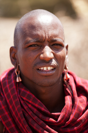 Amboseli, Kenya - February 07, 2012 - Portrait of masai man in typical clothing in masai village in Amboseli national parkのeditorial素材