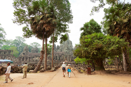 Siem Reap, Cambodia - March 19, 2011: Tourists walking in the area near Bayon Temple admiring its beauty hidden in the treesのeditorial素材