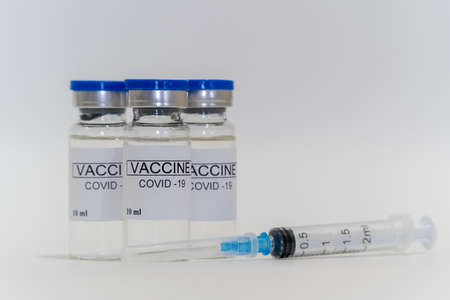 Coronavirus vaccine vials and syringe on a white background. Vaccination Medical Concept - Subcutaneous Injection. Prevention and protection from disease. Healthy lifestyle.の写真素材