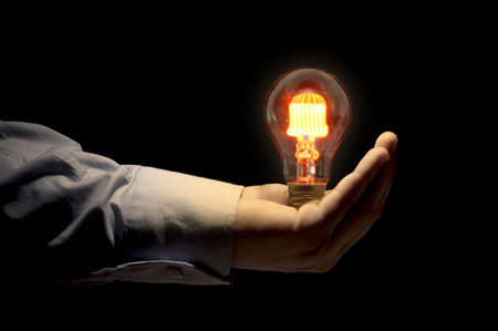 Hand holding light bulb