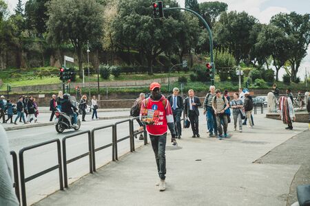 Rome, Italy-April tenth 2019: Different people on the crowded european street. Nature and the road....