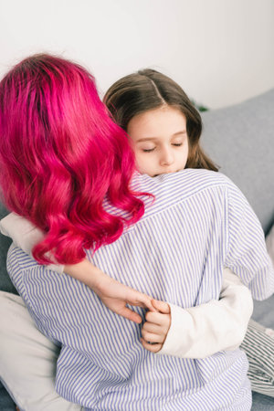 the daughter tenderly embraces her mother and enjoys their presence in her lifeの写真素材