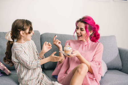 daughter and mother sincerely laugh and enjoy the day spent togetherの写真素材