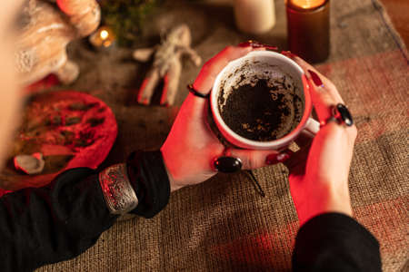 Divination on coffee grounds. The witch guesses the fate of man over coffee.