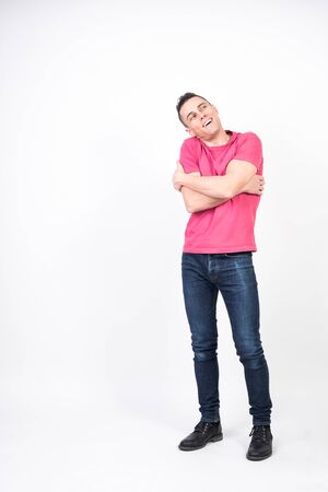 Man in love hugging himself. white background, full bodyの写真素材