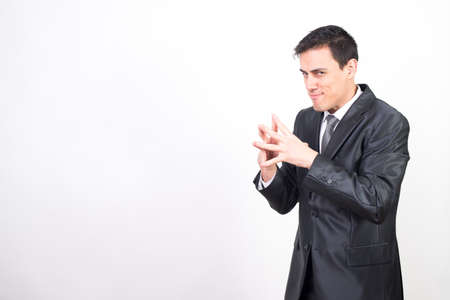 Evil man in suit machining a devilish plan. Medium plane, white backgroundの写真素材