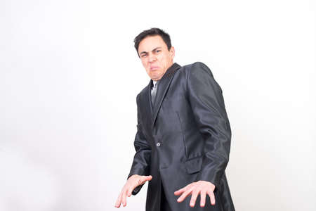 Disgusted man in suit retreating, on white background. Middle planeの写真素材