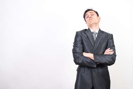 Self-confident man in suit. White background, medium shotの写真素材