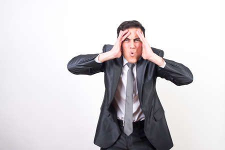 Surprised man in suit. White background, Medium shotの写真素材