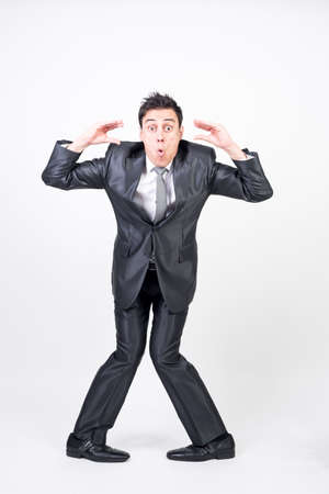 Silly man in suit. White background, full bodyの写真素材