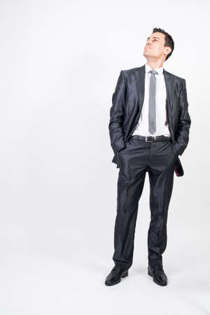 Optimistic man in suit. White background, full bodyの写真素材