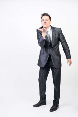 Seductive man in suit. White background, full bodyの写真素材