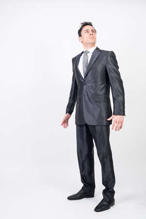 Arrogant man in suit. White background, full bodyの写真素材