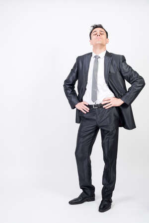 Arrogant man in suit. White background, full bodyの写真素材
