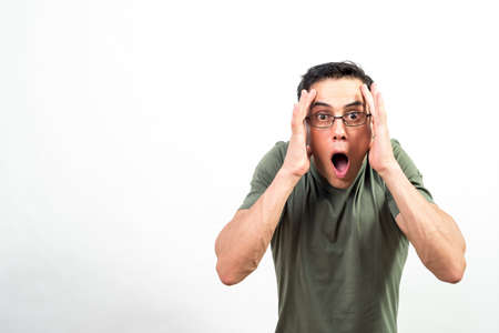 Surprised man with glasses looking at camera. Mid shot. White background.の写真素材