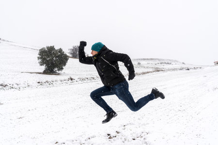 Side view of person running in a snowy landscape. Madrid. Spainの写真素材