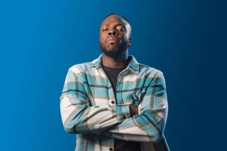 Handsome black man, serious and angry, crossed arms.