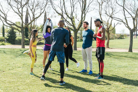 Group of friendly runners talking in a park before training.の写真素材