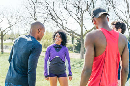 Group of friendly runners talking in a park before training.の写真素材