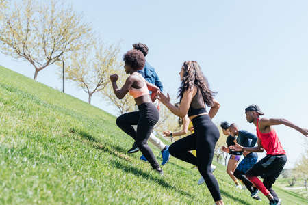 Group of runners running up a hill.の写真素材