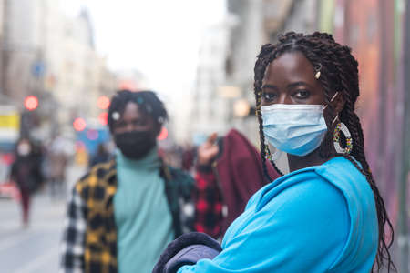 Black couple in the city. With masks.の写真素材