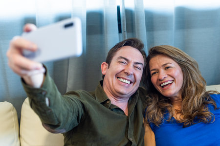 Smiling mature man and woman taking a selfie.