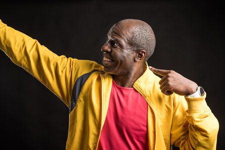African American man standing looking and pointing to the side