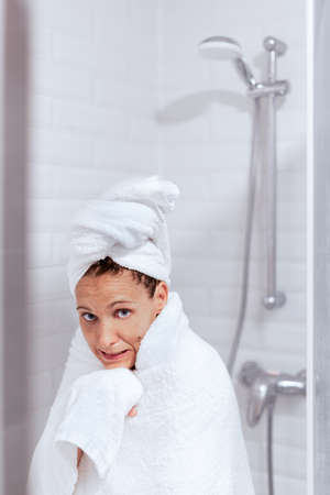Woman comes out of the shower with very coldの写真素材