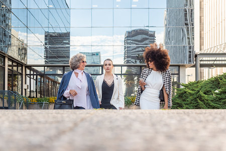 three business women leaving work talking to each otherの写真素材