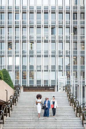 women entrepreneurs walking down the stairs after workの写真素材