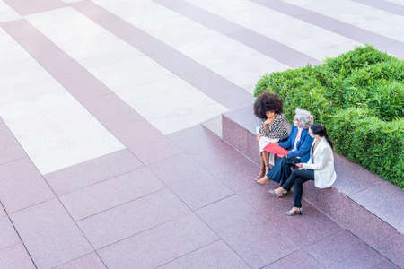 top view of businesswomen sitting and talkingの写真素材