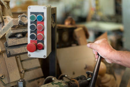 person controlling machinery in a factory, foreground