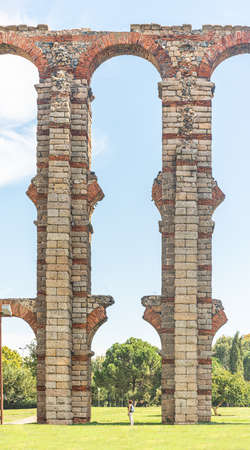Tourist under stone arches of Miraculous aqueductの写真素材