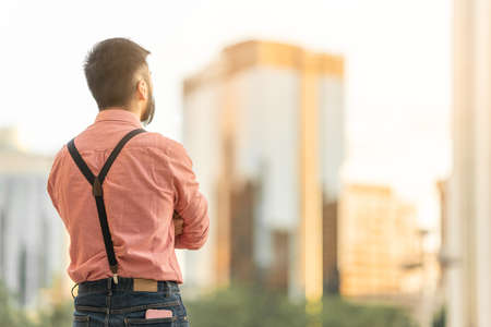 Back of a man looking the city landscape with skyscrapersの写真素材